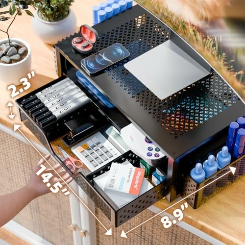 Metal desktop organizer with drawers and assorted office supplies, dimensions labeled.