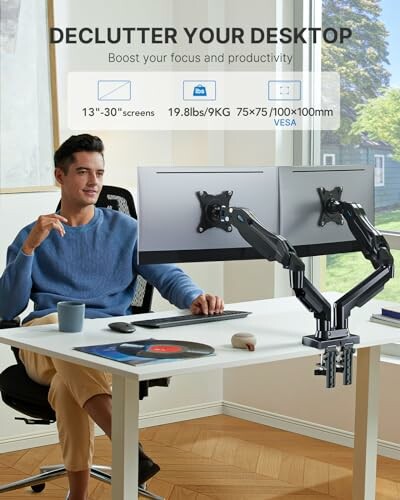 Person using dual monitor arm setup at desk